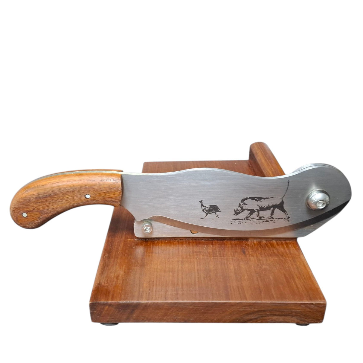 Wooden-handled knife with engraved design on a wooden stand against a white background