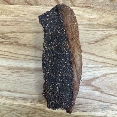 Full piece of Original biltong from Biltong Direct arranged on a wooden surface.