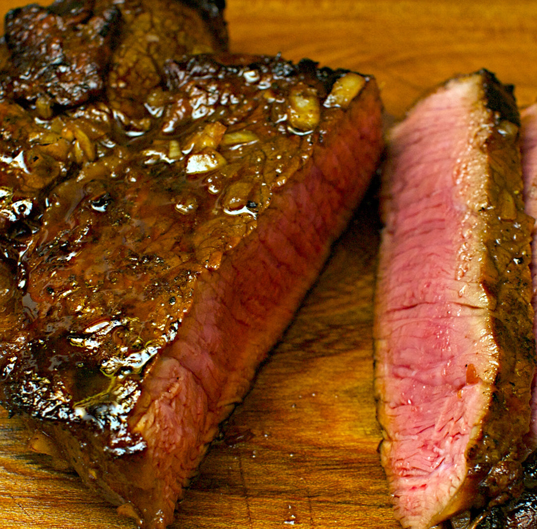 A photo showing a cooked beef steak from Biltong Direct, with a focus on the thick cut and the marination.