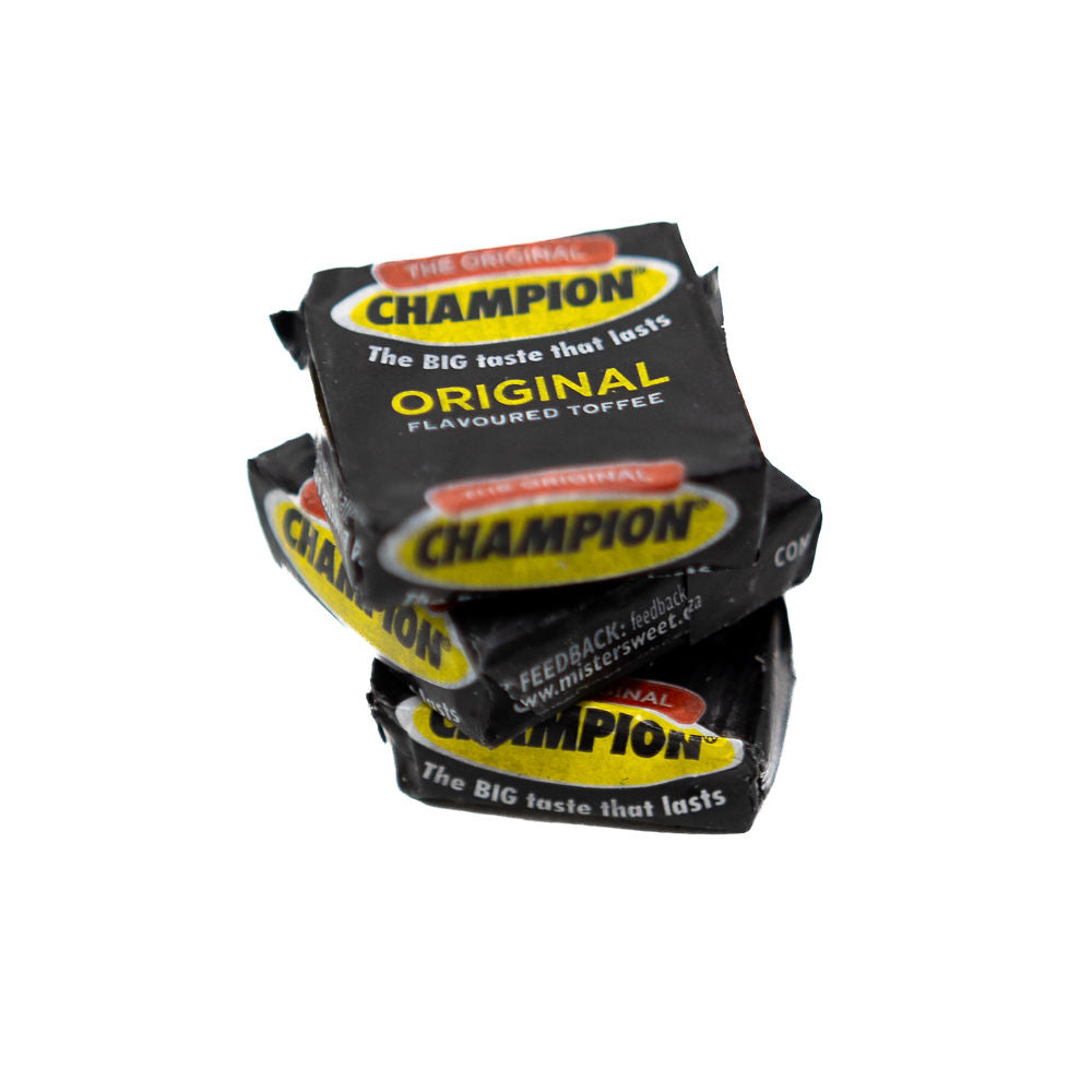A stack of black and yellow candy wrappers labeled 'Champion Original' representing Wilson Toffees from Biltong Direct.