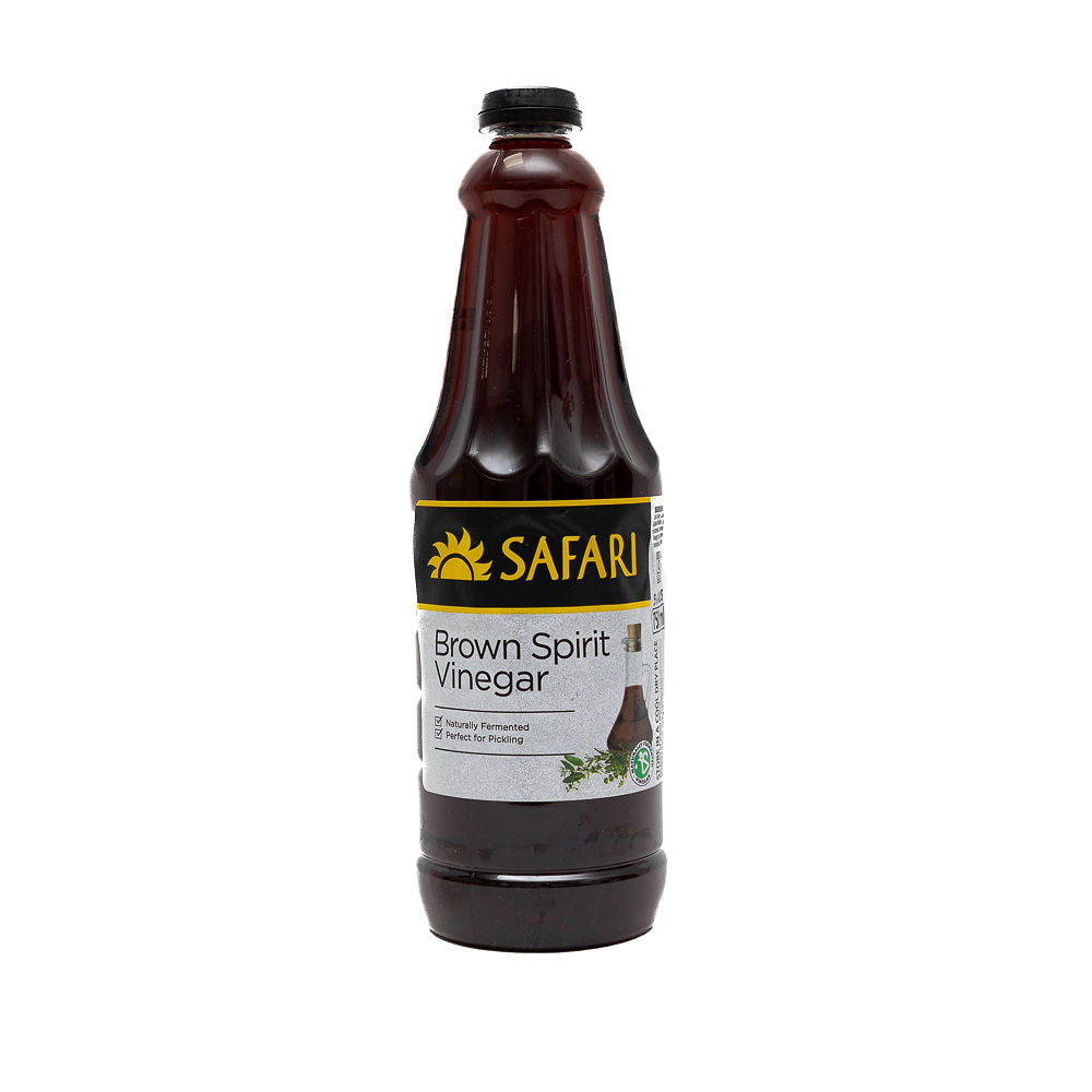 A bottle of Safari Brown Vinegar from Biltong Direct with a label showing the brand name and the product name, Brown Spirit Vinegar, with a background of herbs.