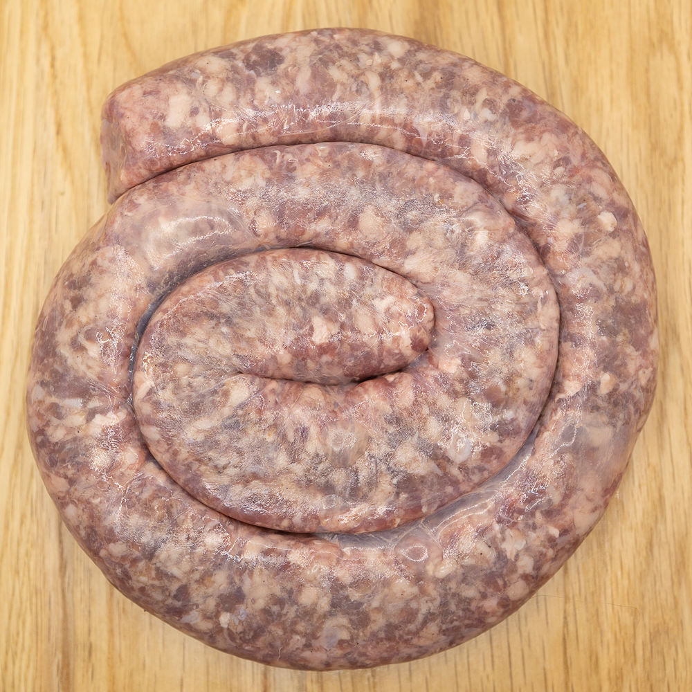 A large, coil of boerewors sausage from Biltong Direct on a wooden surface.