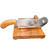 Wooden-handled knife with engraved design on a wooden stand against a white background